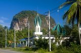 Krabi Province is made up of more than 5,000 sq km of jungle-covered hills and sharp, jagged karst outcrops, as well as more than 100km of luxuriant, pristine coastline and around 200 islands in the neighbouring Andaman Sea.<br/><br/>

About 40 per cent of the provincial population is Muslim, the remainder being predominantly Buddhist. This is a clear indication that Krabi sits astride the invisible dividing line between Buddhist Thailand and the four southern provinces—Satun, Narathiwat, Yala and Pattani—which are predominantly Muslim. Far from causing any sort of problem, this adds immensely to the cultural width and diversity of the province, blending mosques with temples, Malay cooking traditions with Thai cuisine, and giving the province a pleasantly relaxed multi-cultural feel.