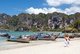 Thailand: Vendor walks past tour boats lined up on the beach, Hat Rai Leh West, Krabi Coast